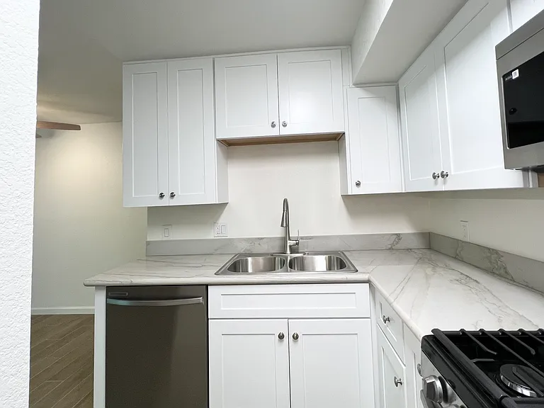 Kitchen Area w/granite countertops, sink, all new modern appliances and tile flooring