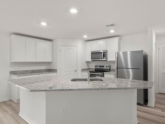 The kitchen comes chef-ready with stainless steel appliances