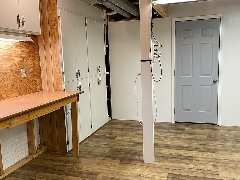 Basement bonus room. Would make a great workout room or workshop. Lots of storage cabinets