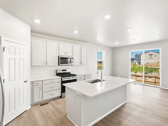 The Snowberry floorplan images taken at a Meritage Homes community in Commerce City, CO.