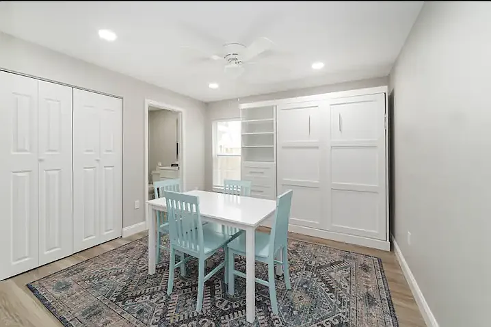 The downstairs murphy bed folds into the wall and the workspace can convert into a dining space.