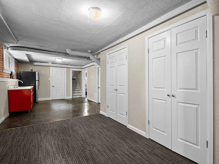 The room with carpet is the 2nd living room with TWO closets!