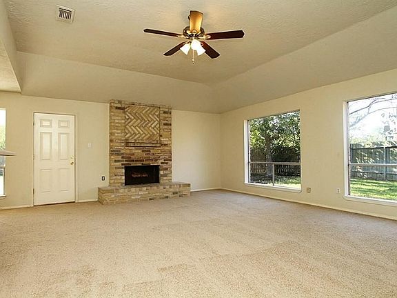 Entry opens to Huge Living Room with New Ceiling Fan & Large Picture Windows!