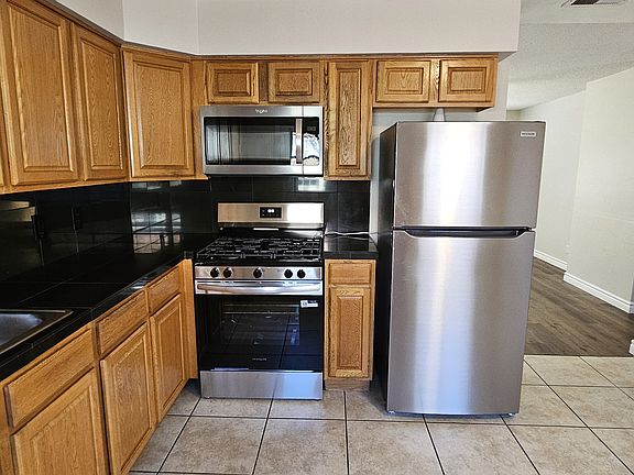 Dine in kitchen with new fridge, stove, food disposal, and 1 year old microwave.