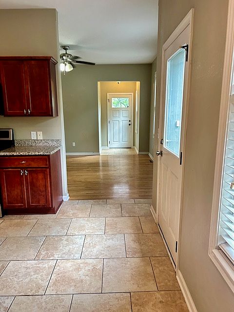 Kitchen view to main living room area to front door.