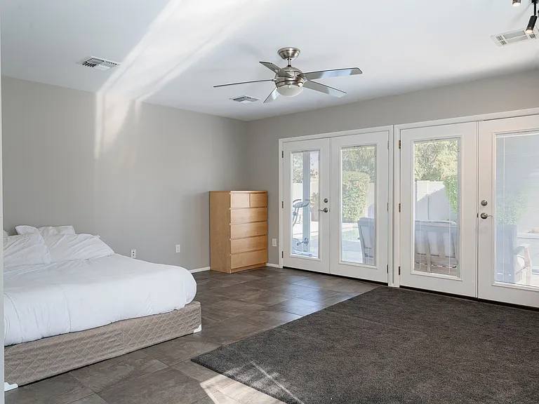 Master bedroom 1 with double door entrance to pool