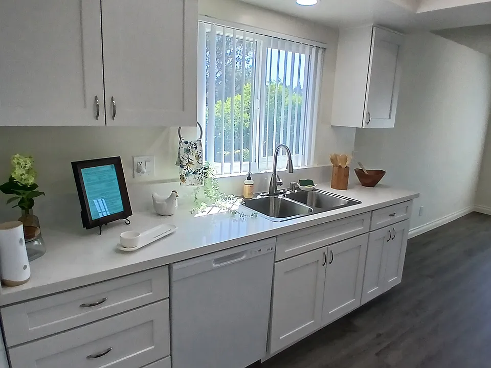 enter to large, bright, kitchen, with all new cabinets, quartz counters, plumbing, lighting. and appliances.