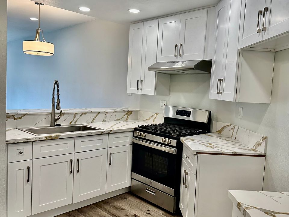 Brand new kitchen with High-end Quartz Countertops, new White Shaker Cabinets, extra-large stainless sink and designer faucet.