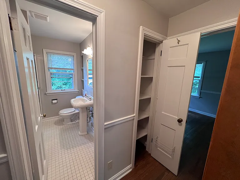 Living area leads to a hallway with full bath on main floor in between two bedrooms, floor is real hardwood.