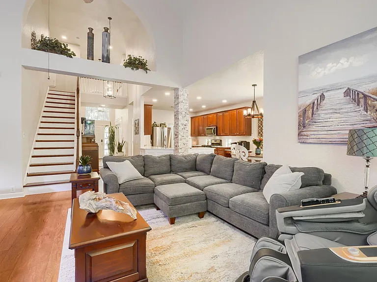 living space with view of upstairs and kitchen