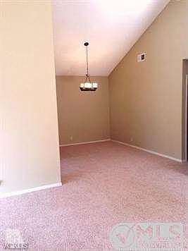 Dining Room with vaulted ceiling - warm brown paint and carpet