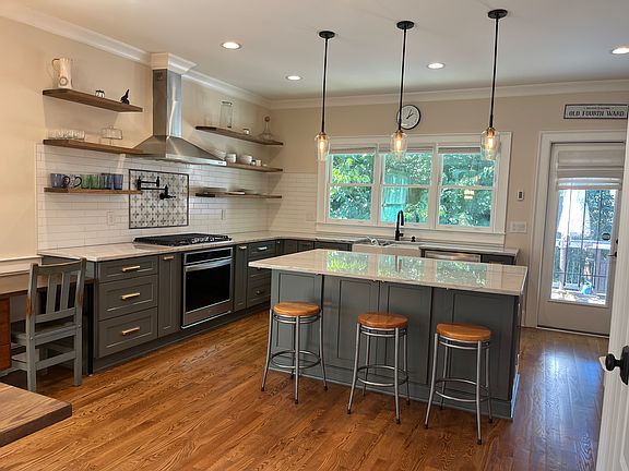 Gourmet kitchen with tons of natural light and access to rear patio