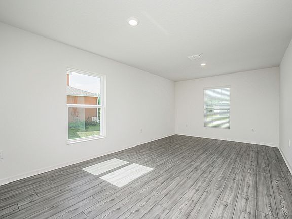 The dining room is spacious and has a lot of natural light