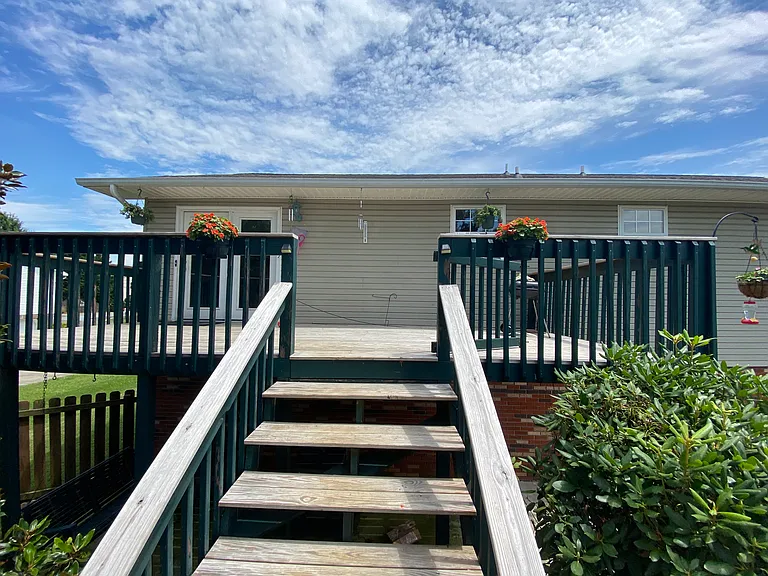 Spacious deck with shaded patio below. Privacy fenced backyard.