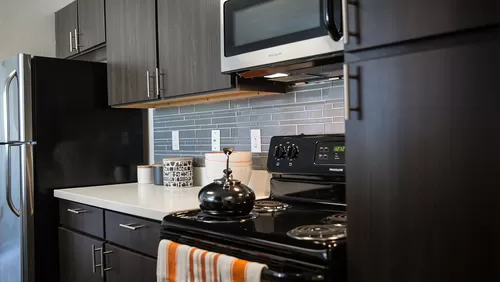 Apartment Kitchen with Stainless Steel Appliances and quartz counters. - Griffis Lafayette Station