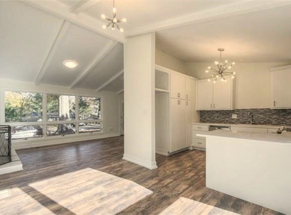 Dining area off kitchen and living room with luxury vinyl plank flooring