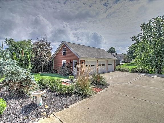 In the back of the home, note the well-designed landscaping that will produce yearly for you.  The 3-stall garage with loft is s