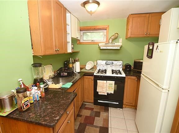 Working kitchen with generous cabinet and counter space.