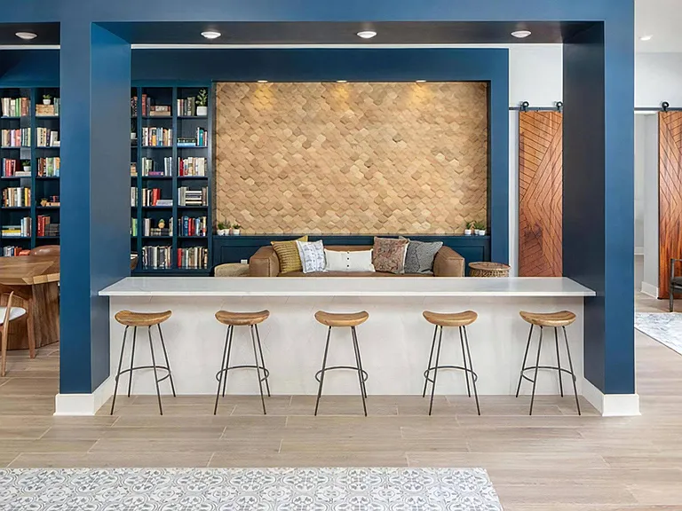 Stylish Common Area with Modern Bar Stools, Lounge Sofa, and Wall Detail