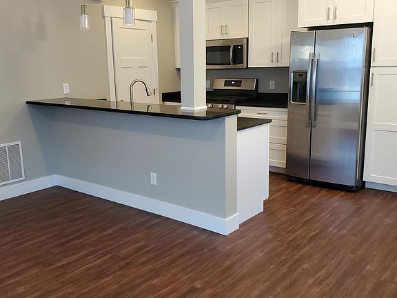 Kitchen area with breakfast bar. Mechanical Room behind the door.