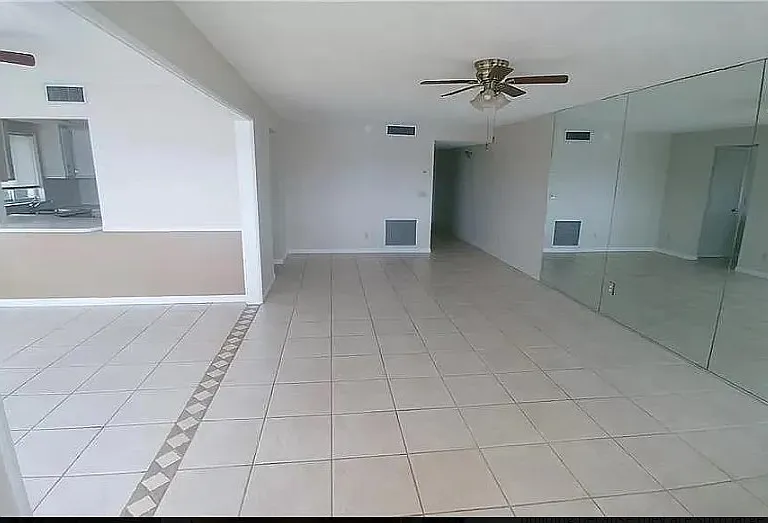 Living Room Area looking towards entrance. The wall on the right to the end is all mirrors.