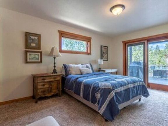 Second bedroom with sliding door to main deck with grill, views, and hot tub
