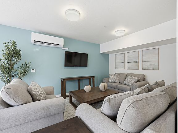 A spacious community room featuring a full kitchen, comfortable couches, and tables_perfect for everyday gatherings or reserving for private parties and special events.