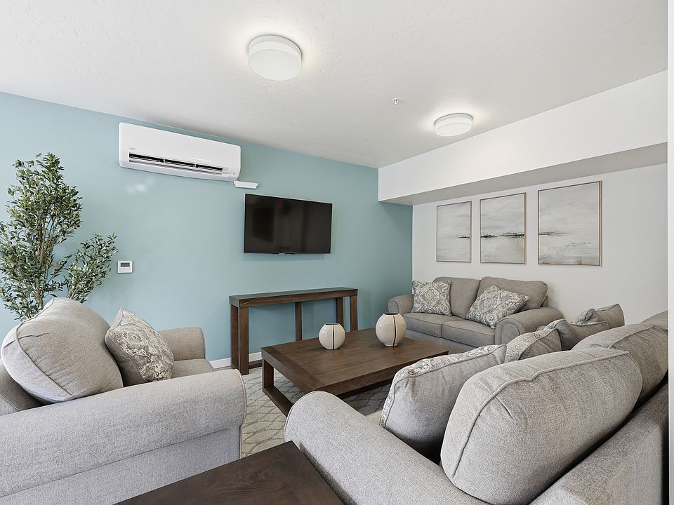 A spacious community room featuring a full kitchen, comfortable couches, and tables_perfect for everyday gatherings or reserving for private parties and special events.