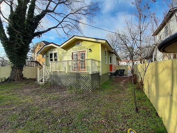 Generous, fenced back yard with south facing deck and dog run to side.