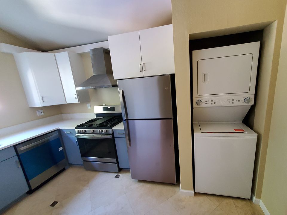 The kitchen area features full-size washer/dryer, refrigerator, gas stove, oven, and dishwasher.