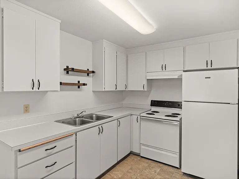 Bright, modern kitchen with sleek white cabinets, electric stove, and ample storage space. Bright, modern kitchen with sleek white cabinets, electric stove, and ample storage space.