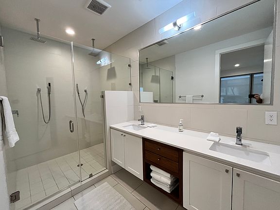 Primary bathroom complete w/ two rainfall shower heads and double vanity