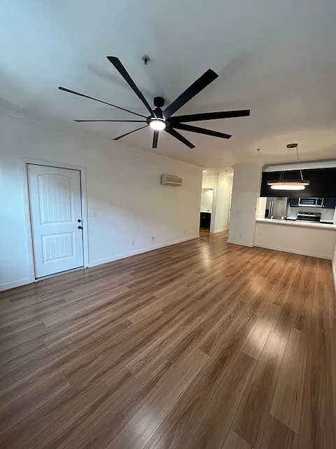 View from the front windows back into the condo to the brand new kitchen with eat at counter. and big ass fan. Unit also has two mini spolit air condtitioing units one in living area and another in the bedroom . Outdoor private balcony to the left - 7598 Monterey St #240