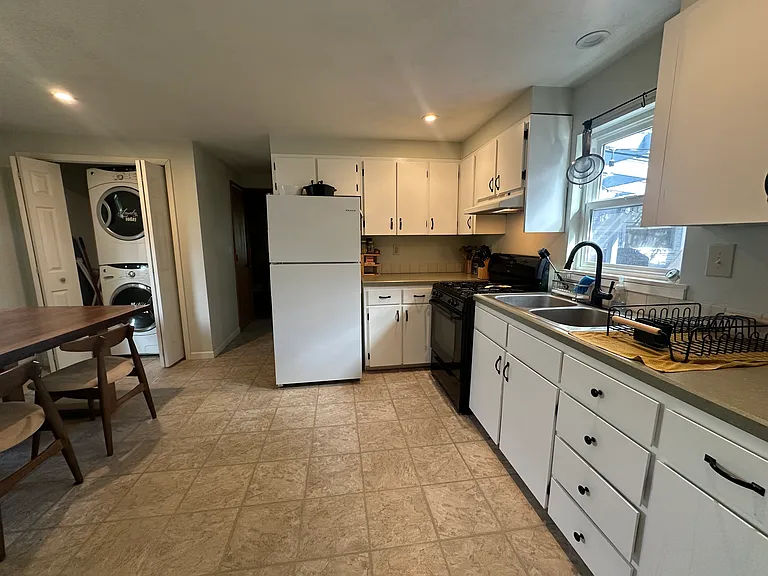 Kitchen with stacked washer and drier