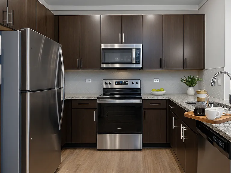 Luxury granite countertops, sleek stainless steel appliances, and espresso-finish cabinetry, this space blends style and function seamlessly.