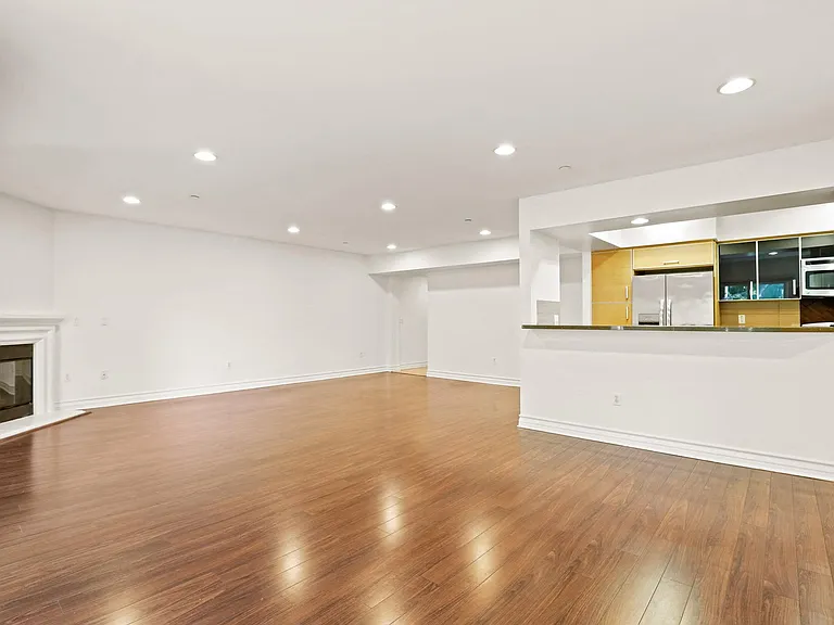 Living Room Area with an Electric Fireplace and Vinyl Flooring