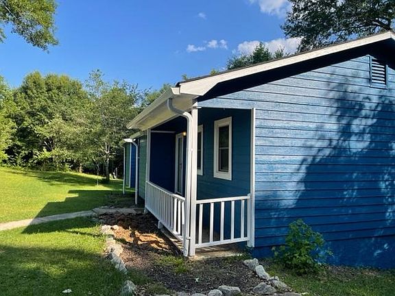 side view of front of house and part of the large lot