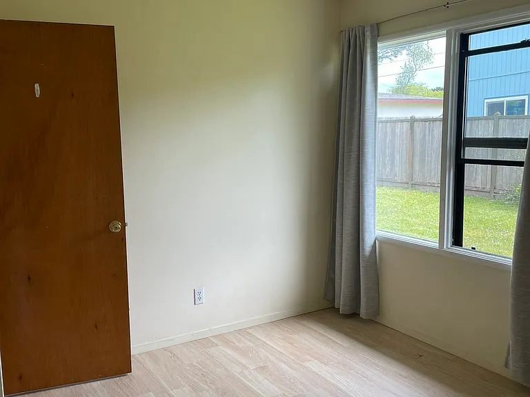 Sunny Dining Room With Door Leading to Garage