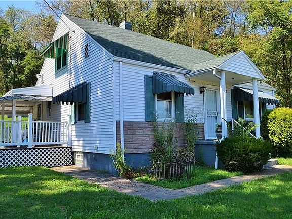 Cute cape cod with inviting covered side porch.