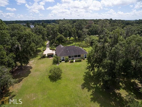 Back view of home.  The lot is 3.02 Acres and offers gorgeous Trees.  No Flood Insurance required here! Great back yard that features large Oak Trees, Fruit Trees.  There is lots of privacy to enjoy views of the wildlife that come by including deer and bi