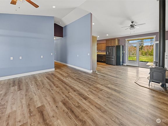 Open concept living with living room and dining area, double french doors, wood stove and awesome vaulted ceilings throughout.>