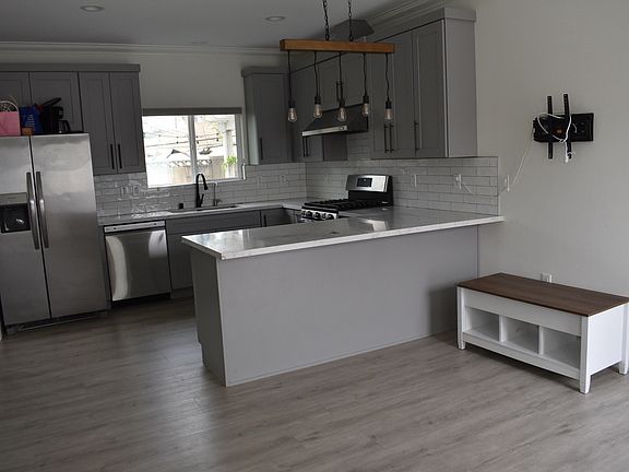 Living room space and kitchen view.