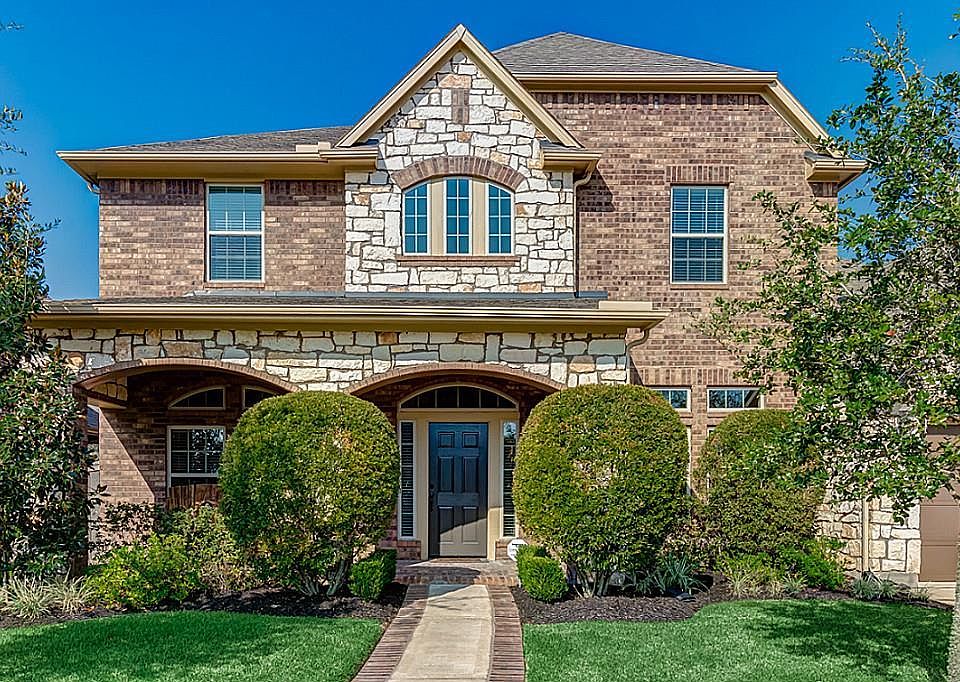 Brick and stone exterior add sophistication to this beautiful 4 bedroom 3.5 bath David Weekly home in Bridgeland!
