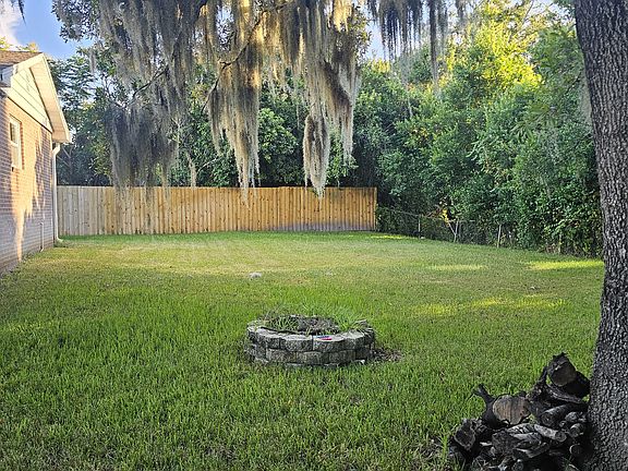 Nicely shaded backyard with lush green grass!