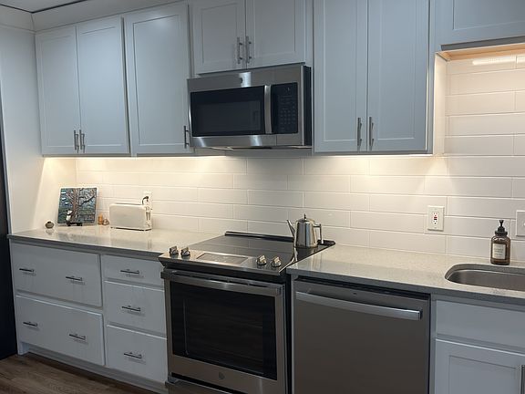 Soft close cabinets. Under cabinet lighting with multiple colors and brightness. Microwave vents outside of home.