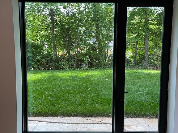 8 ft windows looking outside to the backyard.