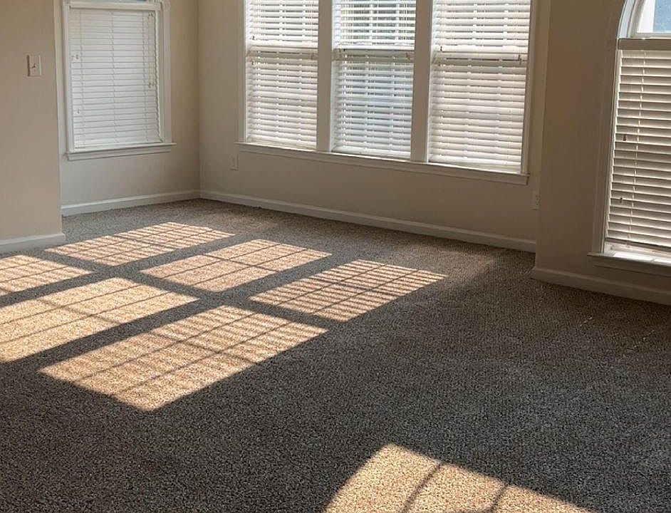 Extra large living room with beautiful windows and natural light.