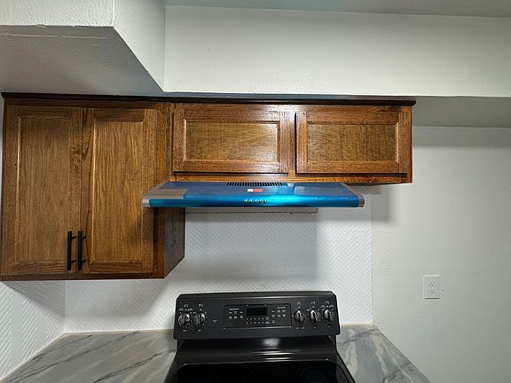 Get ready to cook in this stylish kitchen! You'll love the warm wood cabinets and the modern, sleek range hood. The new counters and backsplash make cleaning up a breeze. Stove Included.