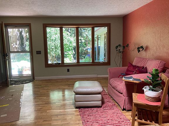 Bay window in living room with view of gardens.