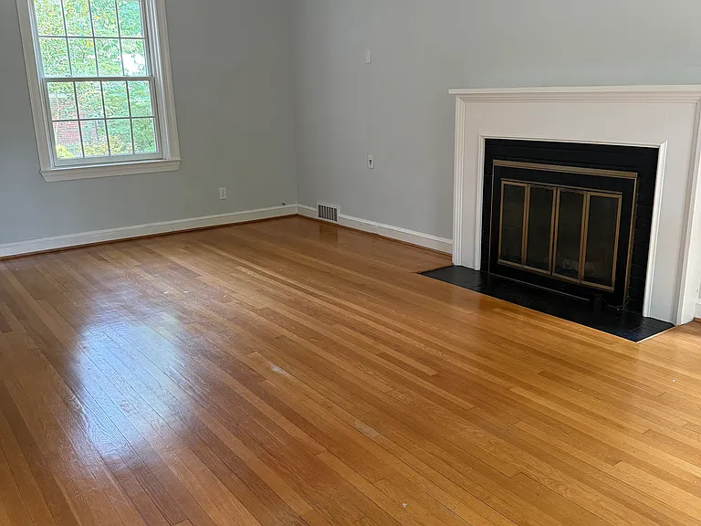 Large living room with wood burning fireplace.
